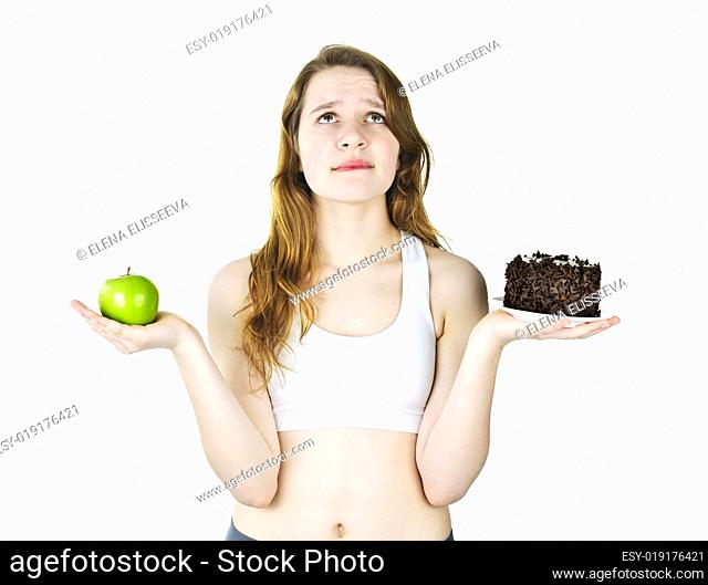 Young girl holding apple and cake