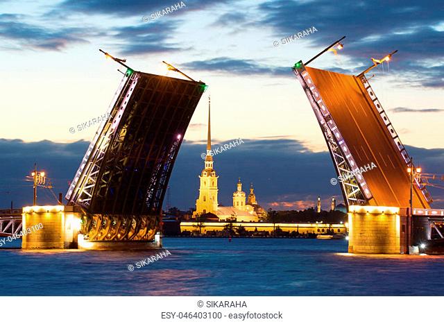 Peter and Paul Cathedral in the alignment of the diluted Palace Bridge on a white night. Saint-Petersburg, Russia