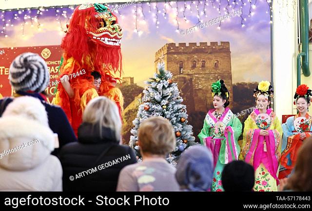 RUSSIA, MOSCOW - FEBRUARY 4, 2023: Visitors look at a lion dance performer during a Lantern Festival celebration held on the premises of the exhibition ""The...