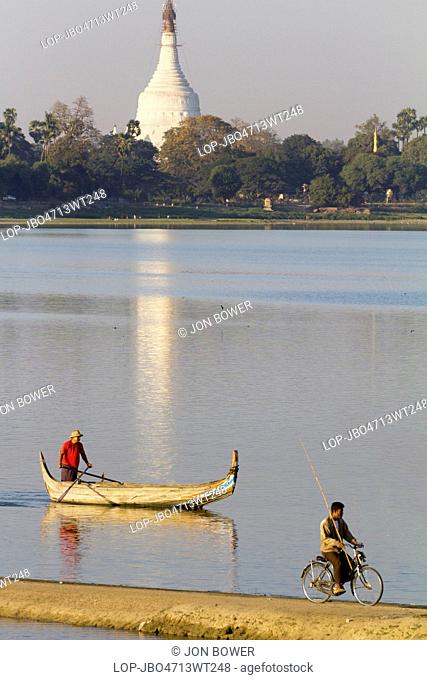 Myanmar, Mandalay, Lake Taungthaman. Bicycle and tourist boat racing on Taungthaman Lake in Myanmar