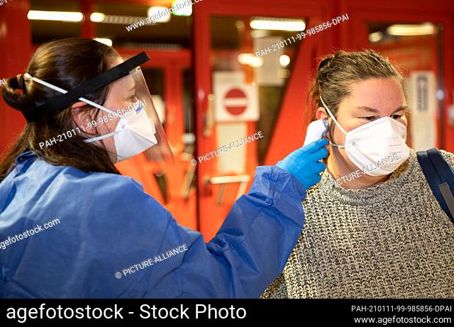 11 January 2021, Lower Saxony, Osnabrück: Medical personnel check the body temperature of residents in an evacuation center who had to leave their homes due to...