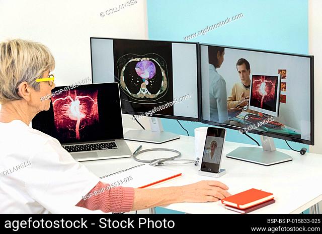 Teleconsultation between two doctors with medical images of stomachs on one of the screens