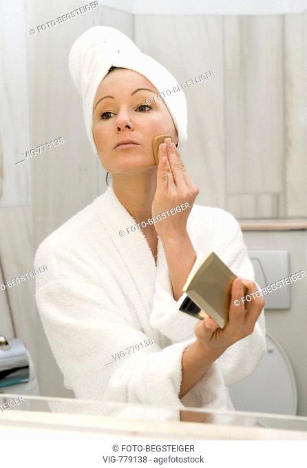 young woman in bath takes face powder. - 04/05/2008