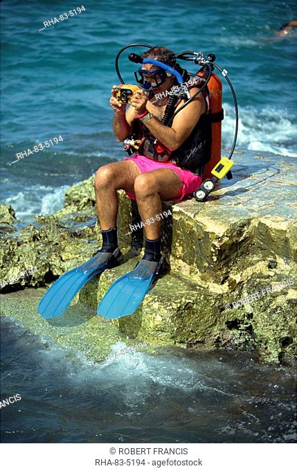 Man preparing to dive at Chankanaab Park, famous for its superb coral reef, on the island of Cozumel, off the Yucatan Peninsula, Mexico, North America