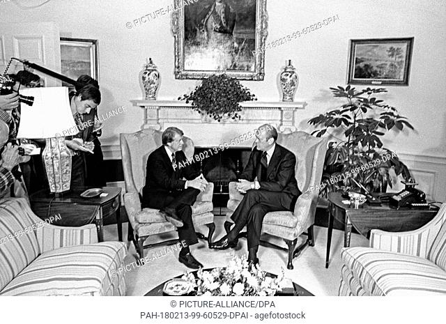 United States President Gerald R. Ford, right, meets U.S. President Elect Jimmy Carter, left, in the Oval Office of the White House in Washington, D.C