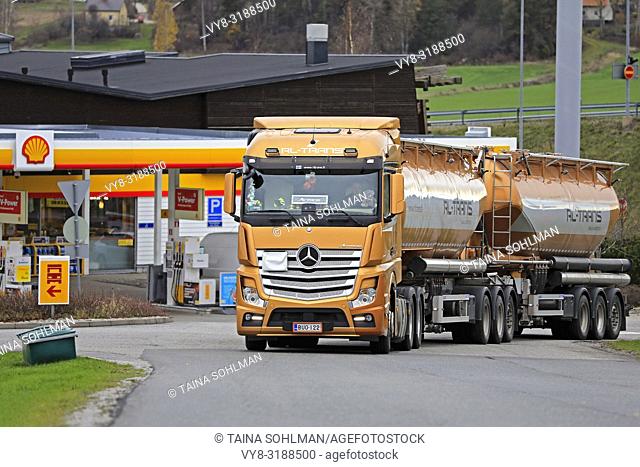 Salo, Finland - October 27, 2018: Orange Mercedes-Benz Actros tank truck of RL-Trans for bulk transport exits Shell filling station in Finland