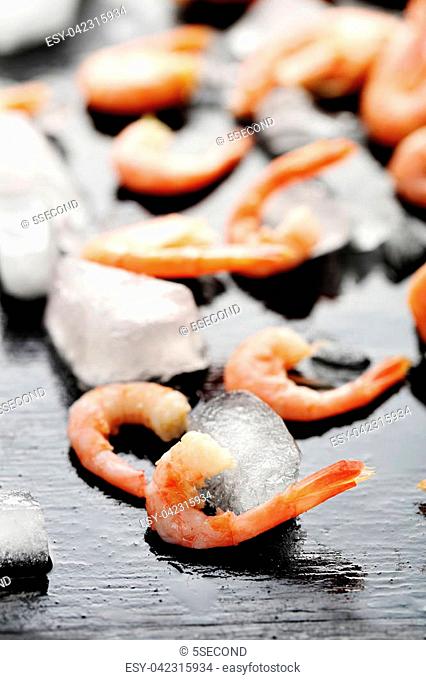 Fresh boiled shrimps on a black wooden table