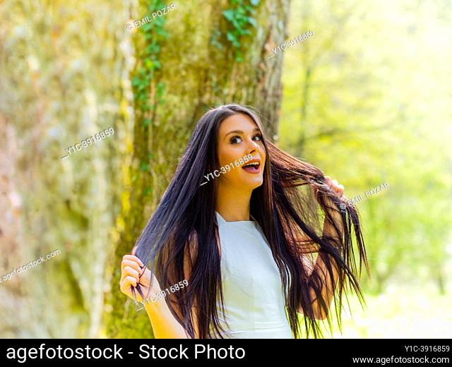 Young woman is excited surprised in nature