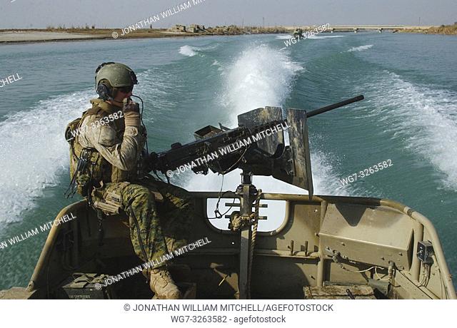 IRAQ Lake Habbaniyah -- 10 Jan 2007 -- A US Marine from Dam Security Unit III mans a weapon aboard a small unit riverine craft during a reconnaissance mission...
