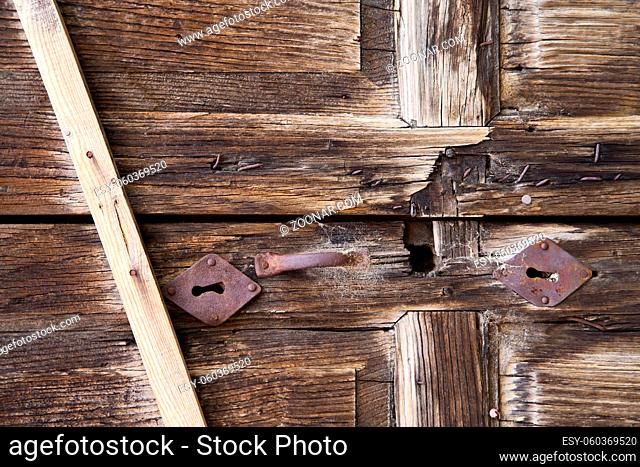 abstract cross  brass brown knocker in a  closed wood door albizzate varese italy