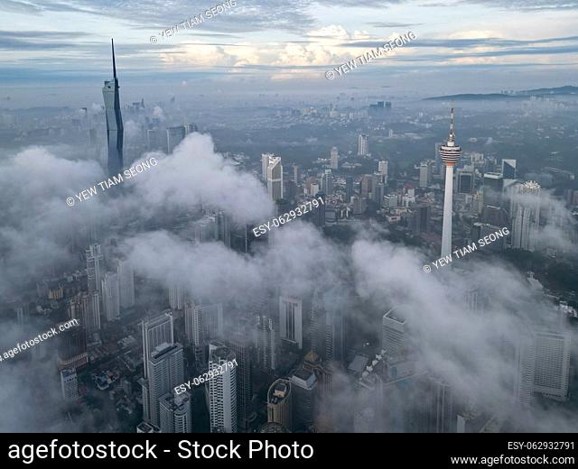 Bukit Bintang, Kuala Lumpur, Malaysia - Nov 13 2022: The low cloud cover creates a dramatic effect, highlighting the KL Tower and Merdeka 118 making it look...