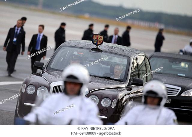 Police officers escort the car of British Queen Elizabeth II and her husband Prince Philip, Duke of Edinburgh, from Tegel airport to the Adlon Hotel in Berlin