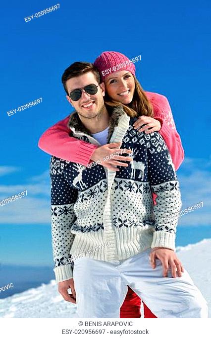 Young Couple In Winter Snow Scene