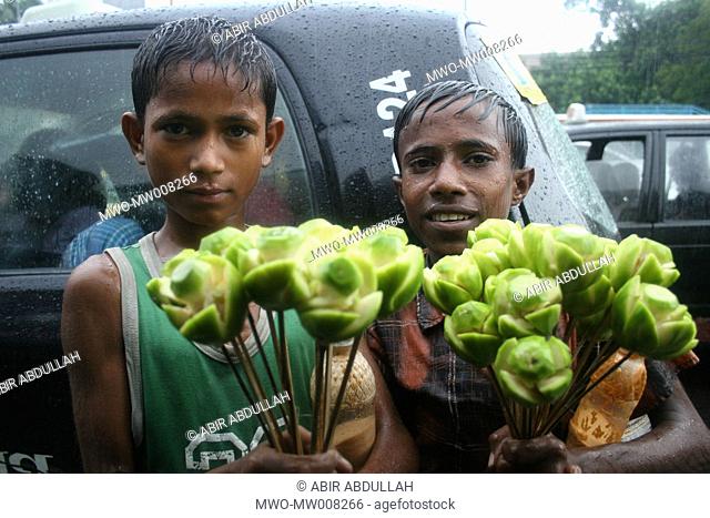 Street children selling hug-plum sticks Dhaka, Bangladesh July 11, 2005