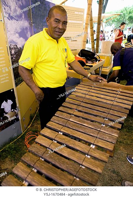 Afro-Colombian Raisal xylophone maker stands proudly behind his creation