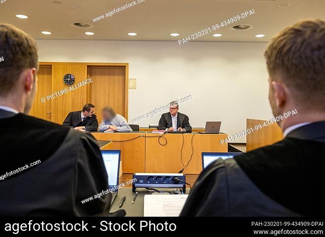 01 February 2023, Bavaria, Augsburg: The defendant (M) sits in the dock at the Criminal Justice Center with his attorneys Detlev Binder (r) and Florian Engert...