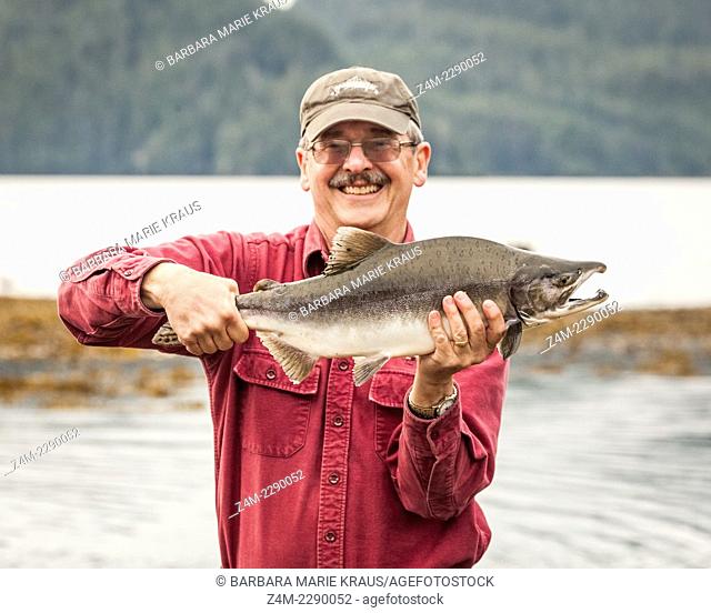 A man fishes with 8# fly fishing tackle at the mouth of a river near Sitka AK during the salmon run
