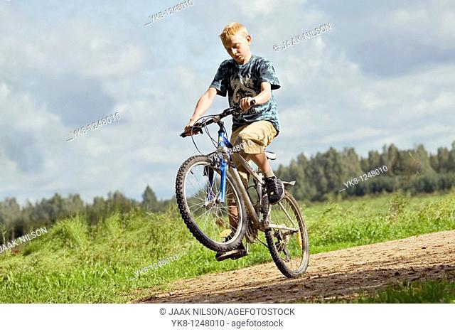 Teenage Boy Riding Bicycle and Doing Action Trick
