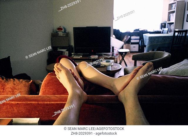 A portrait of the soles of a couple's feet touching intimately