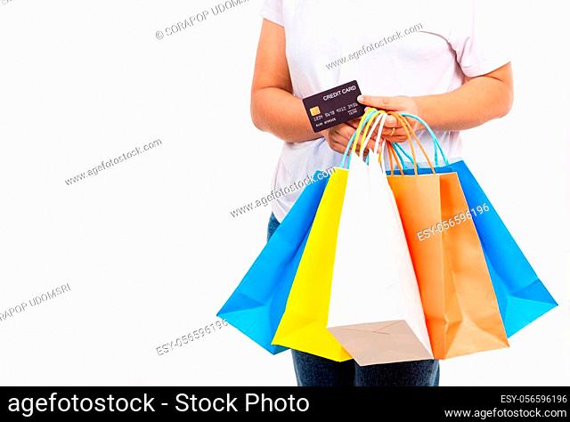 Happy woman hand holding shopping bags multicolor and credit card for shopping online, young female hold many packets within arms isolated on white background