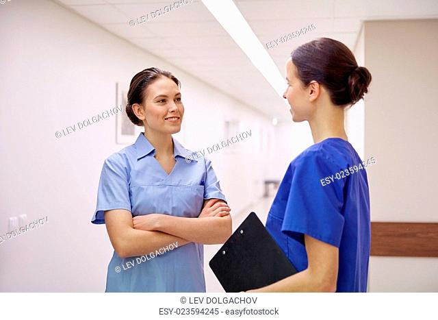 clinic, profession, people, health care and medicine concept - nurses or doctors talking at hospital