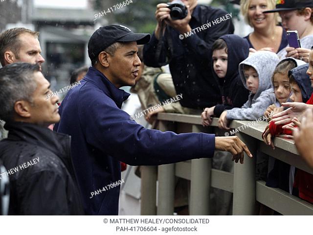 United States President Barack Obama, chats with onlookers in front of Nancy's Restaurant before placing a take-out order in Oak Bluffs