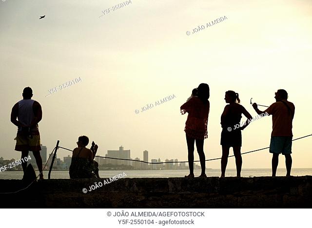 Visitiors enjoying the view of Havana's Malecón and skyline from the fort accross the bay