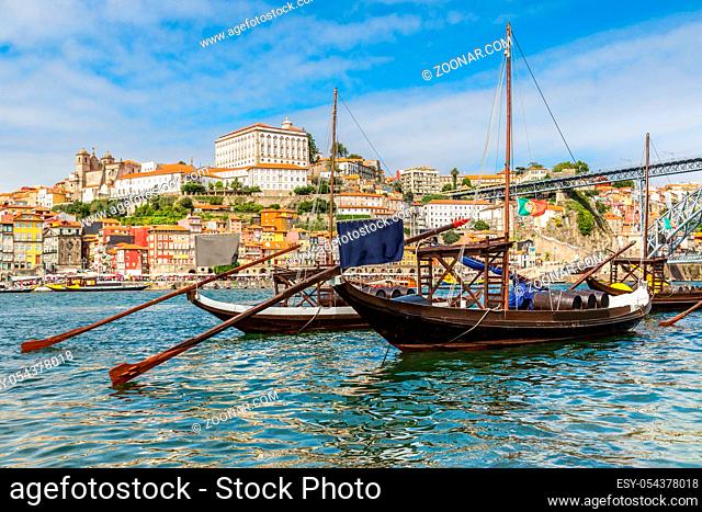 Porto and old traditional boats with wine barrels in Portugal in a summer day