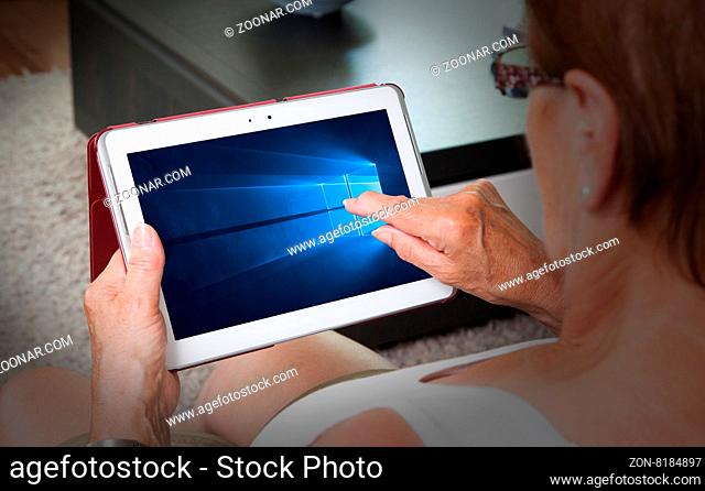 HEERENVEEN, NETHERLANDS, June 6, 2015: Tablet computer with Windows 10 background. Windows 10 is the new version of Windows OS by Microsoft Corporation; it...