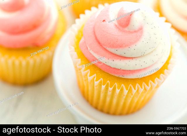Vanilla cupcakes topped with strawberry cream