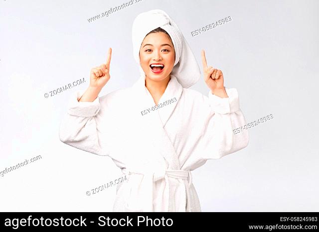 Beauty portrait of young woman showing beauty product and empty copy space with finger pointing, asian beauty