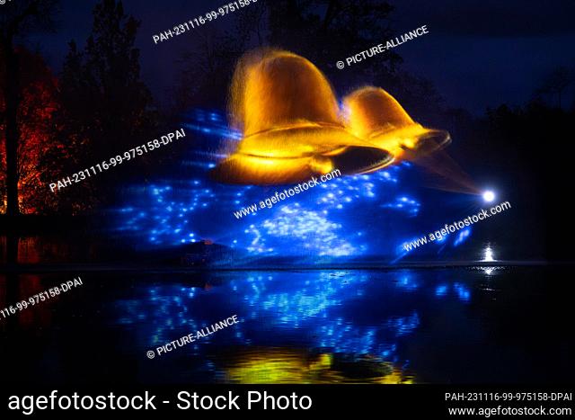 dpatop - 16 November 2023, Saxony, Dresden: Bells are projected into a fountain of water in the pleasure garden to mark the opening of the ""Christmas Garden""...