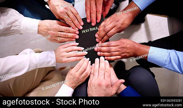 Overhead View Of Hands Holding Holy Bible