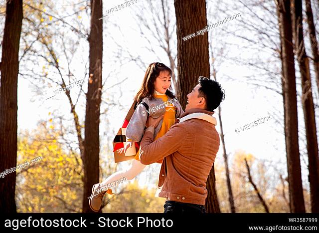 The happy father and daughter playing outdoors