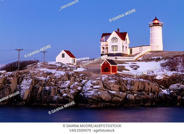 Twilight falls over Cape Neddick Lighthouse also known as Nubble Light in York, Maine