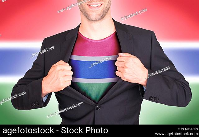 Businessman opening suit to reveal shirt with flag, Gambia