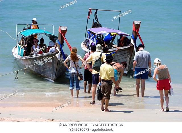Visitors board long tail boats on Ao Nang Beach to get to other beaches and resorts Thailand