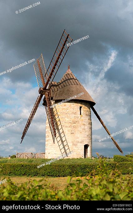 Hauville, Eure / France - 15 August 2019: vertical view of the historic windmill Moulin de Pierre in Hauville in Normandy