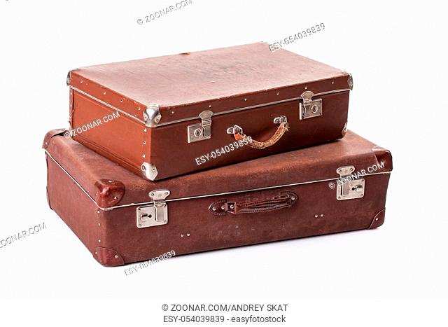 Two old suitcases on an isolated studio background