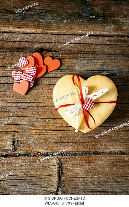 Stack of heart-shaped shortbreads tied with ribbon on wood