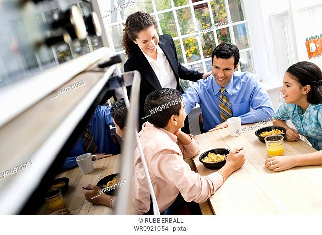 Family at breakfast table smiling