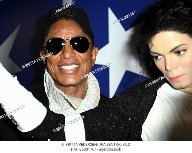 The US singer Jermaine Jackson (L) standing next to the wax figure of his brother Michael Jackson at the Madame Tussauds wax museum in Berlin, Germany