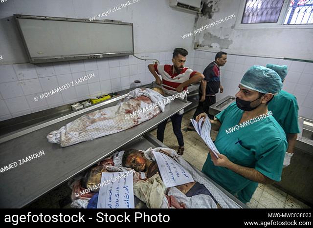 Bodies at the hospital mortuary. Eight children and two women, all belonging to the Abu Hatab family, were killed in the three-storey building in Shati refugee...