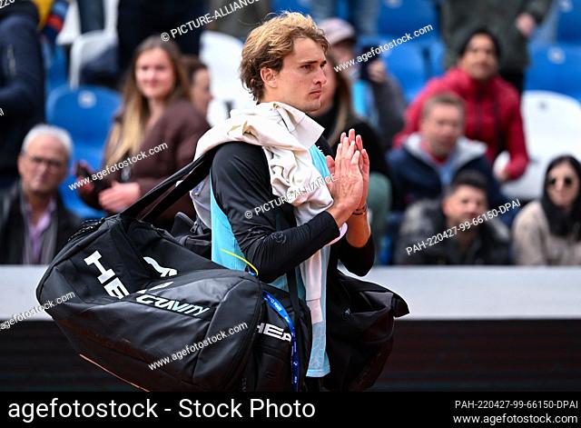 27 April 2022, Bavaria, Munich: Tennis: ATP Tour - Munich, Singles, Men, Round of 16 Zverev (Germany) - Rune (Denmark). Alexander Zverev stands on the court...