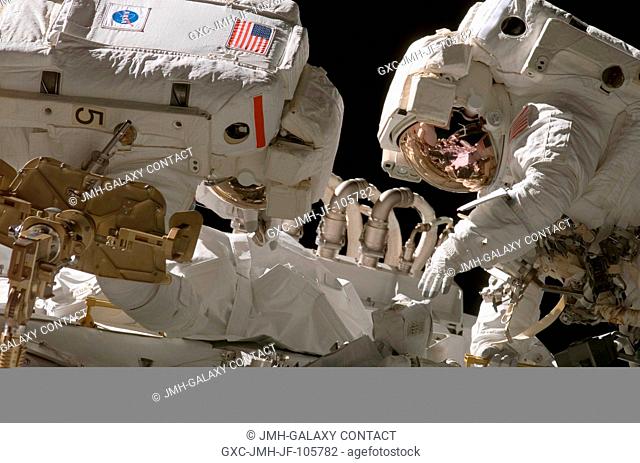 Astronauts Joseph R. Tanner (left) and Heidemarie M. Stefanyshyn-Piper, both STS-115 mission specialists, work in tandem during the mission's first session of...