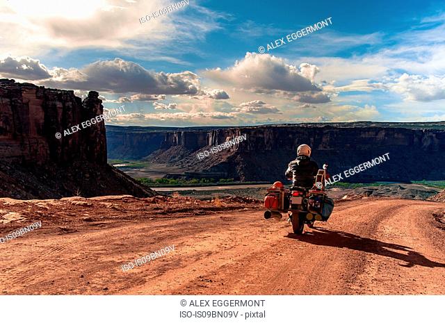 Biker on rock climbing route, Canyonlands National Park, Moab, Utah, USA