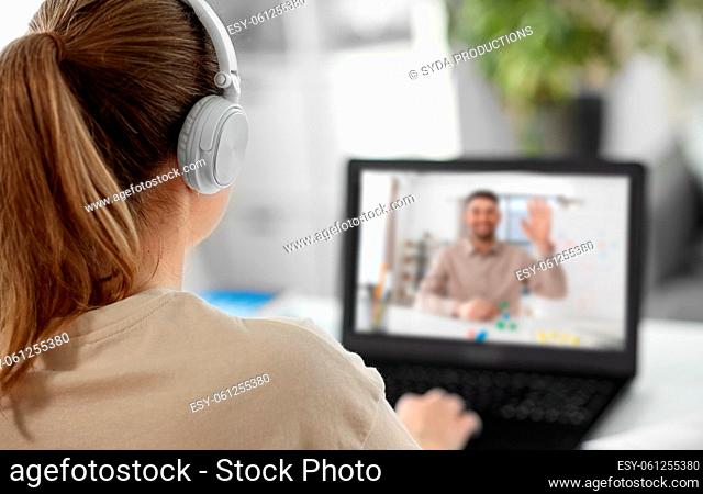 student with laptop having online class at home