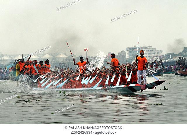 Bangladeshi men row a boat during a traditional boat race on the Buriganga River in Dhaka, Bangladesh, Sept. 28, 2013. The race is an annual event