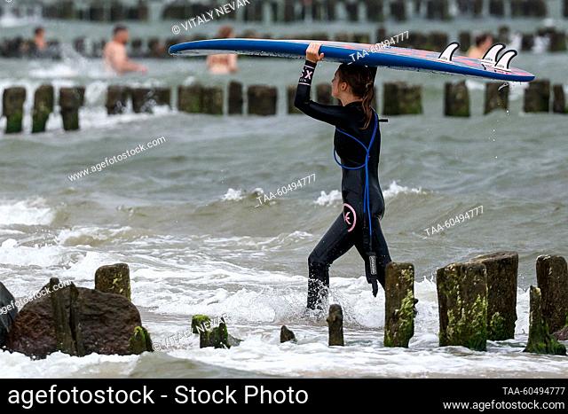 RUSSIA, KALININGRAD REGION - JULY 16, 2023: A woman enjoys surfing off the Baltic Sea coast in Zelenogradsk, 28km north of Kaliningrad