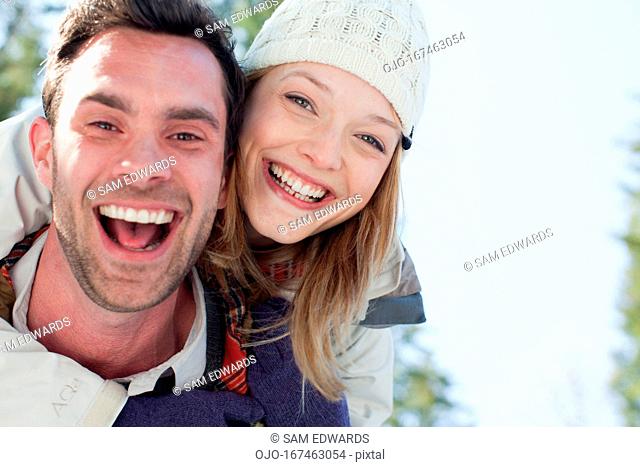 Portrait of smiling couple piggybacking